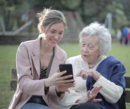 Image of a woman showing an image on her phone to an elderly woman. | Keystone Law