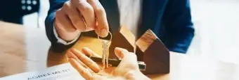 Image of a person handing keys to anyother person. | Keystone Law