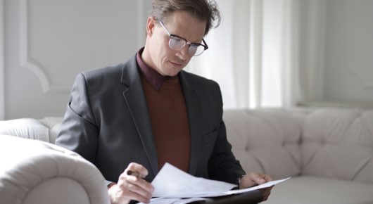 Image of person looking through paperwork. | Keystone Law