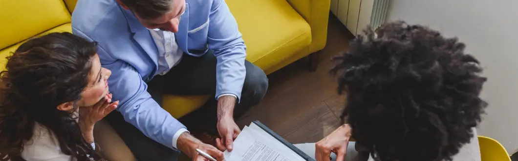 Image of lawyer discussing legal documents with couple. | Keystone Law