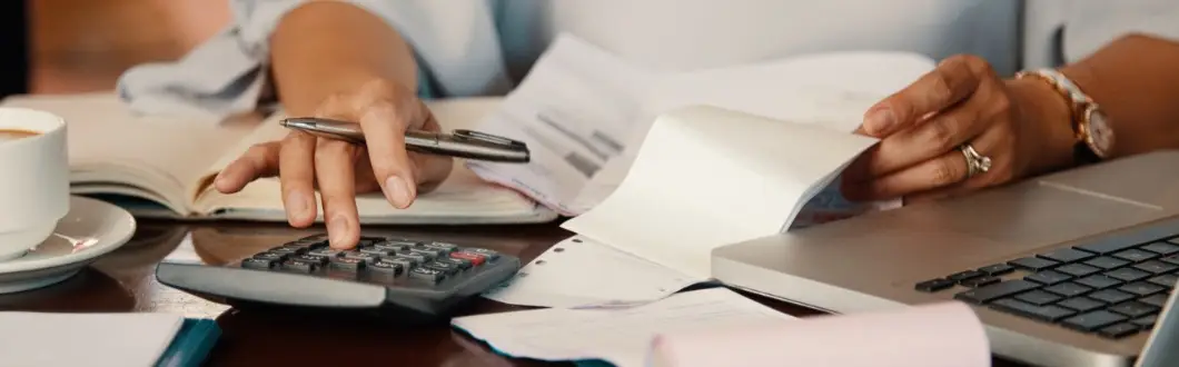 Image of person using a calculator at desk. | Keystone Law