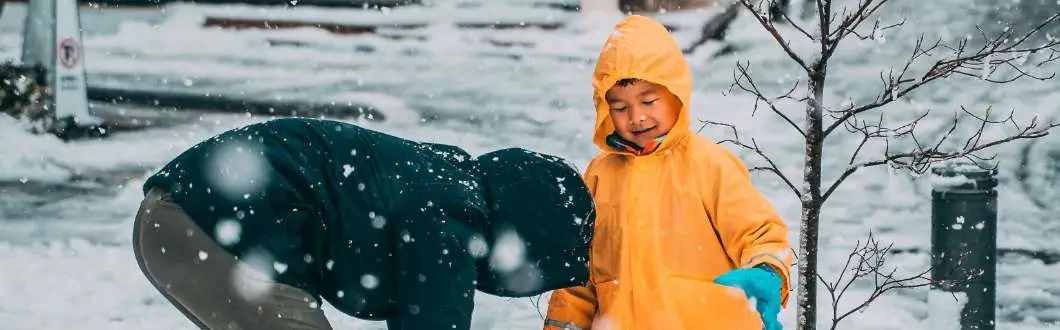family playing in the snow