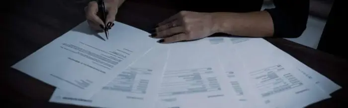 a person signing papers