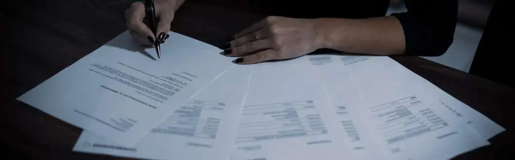 a person signing papers