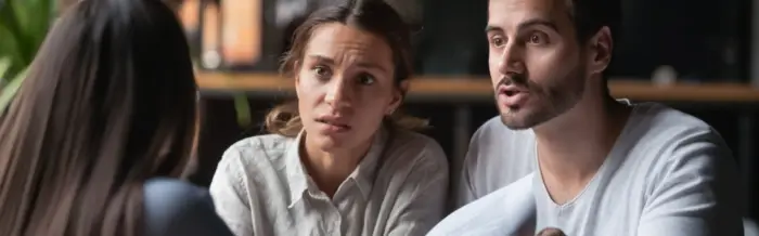 frustrated man and woman discussing paperwork with a third party