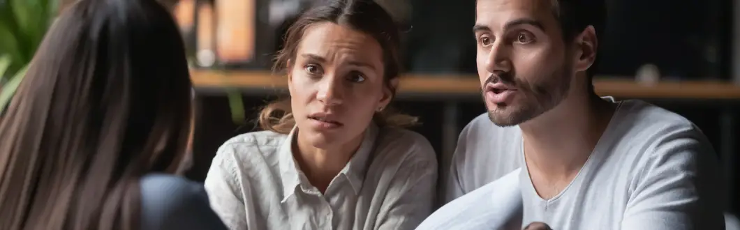 frustrated man and woman discussing paperwork with a third party