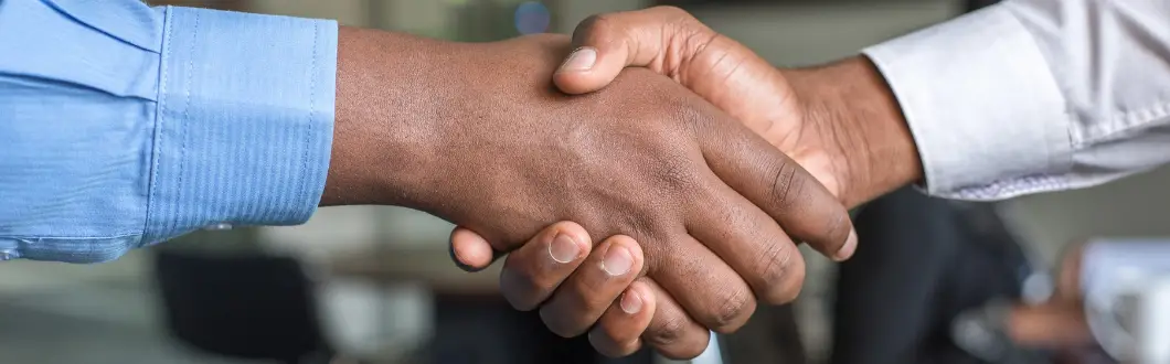 Image of two people in dress shirts shaking hands. | Keystone Law