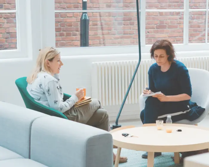 women sitting around a table discussing community property