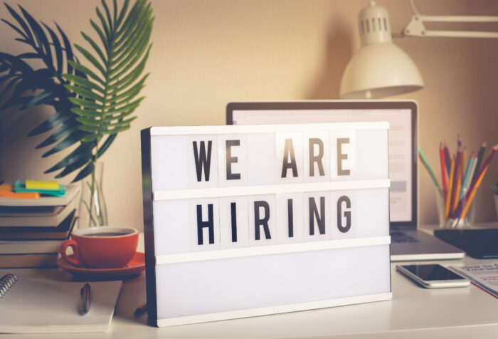We are hiring text on light box on desk office