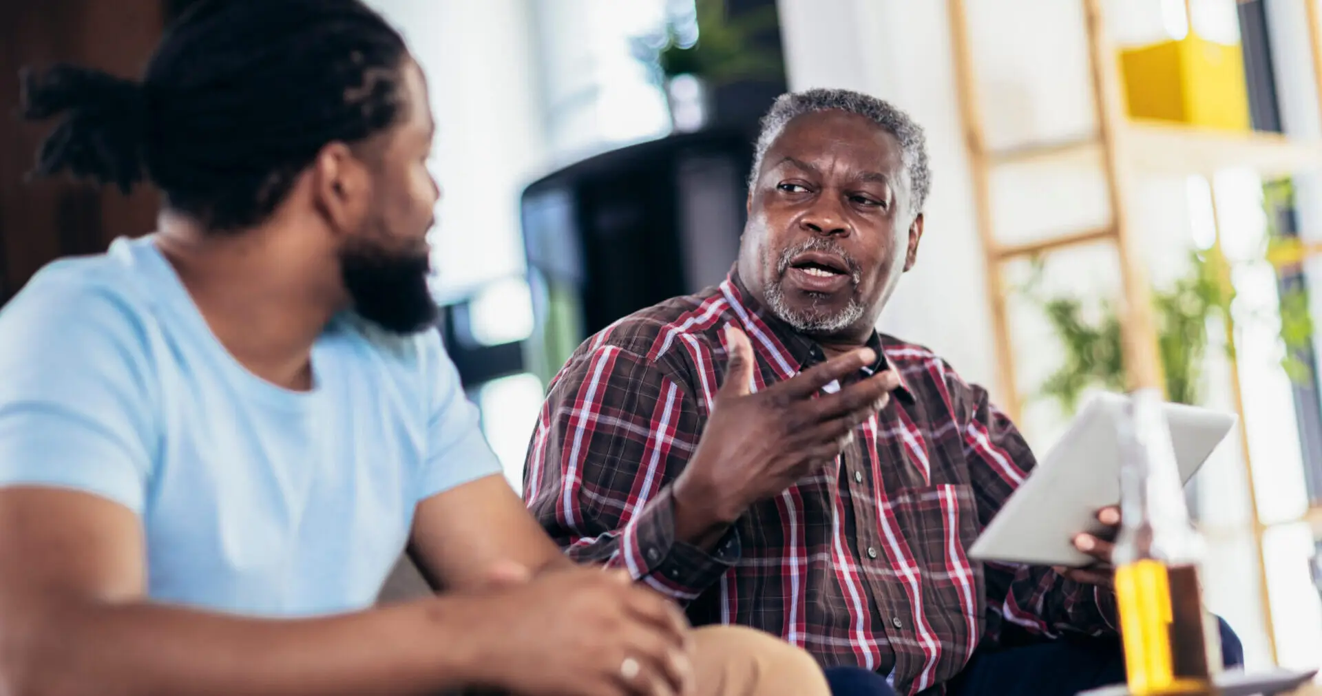 Father and son discussing document in hand
