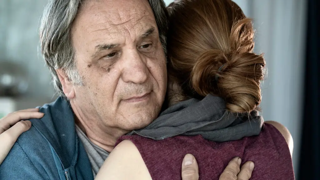 Father and daughter hugging close up view