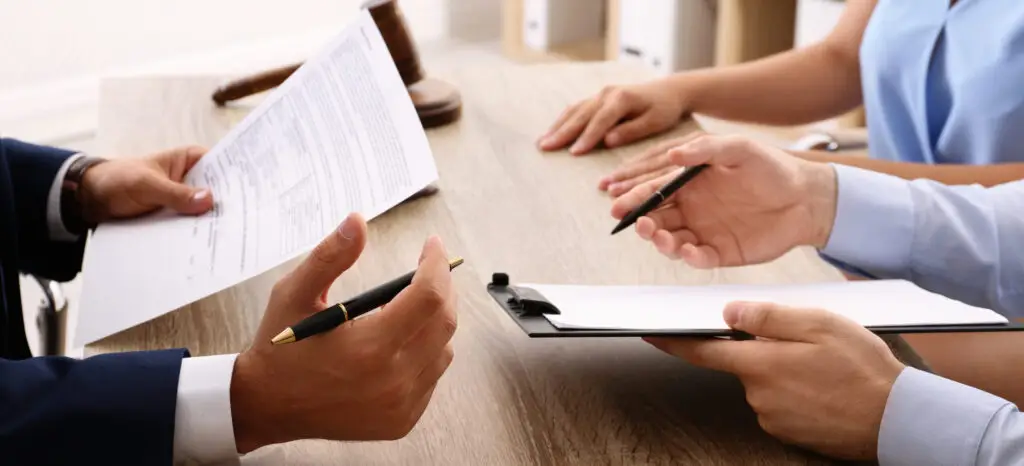 Lawyer working with clients at table in office