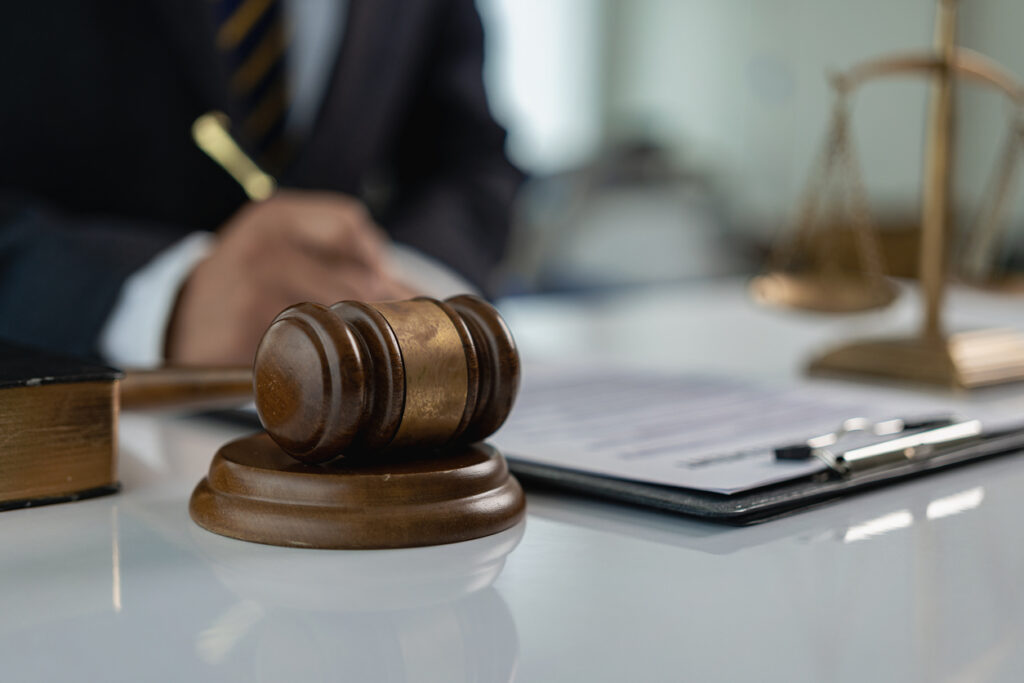 Judge gives hammer and lawyer in suit working on documents Law, advice and justice in office or courtroom, legal advisor with hammer and scales, law, justice concept