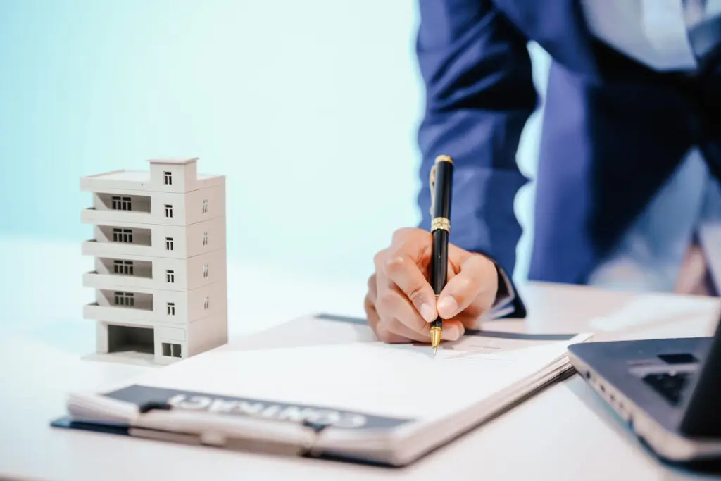 A female employee works at her desk in a real estate office, managing condo sales in the city