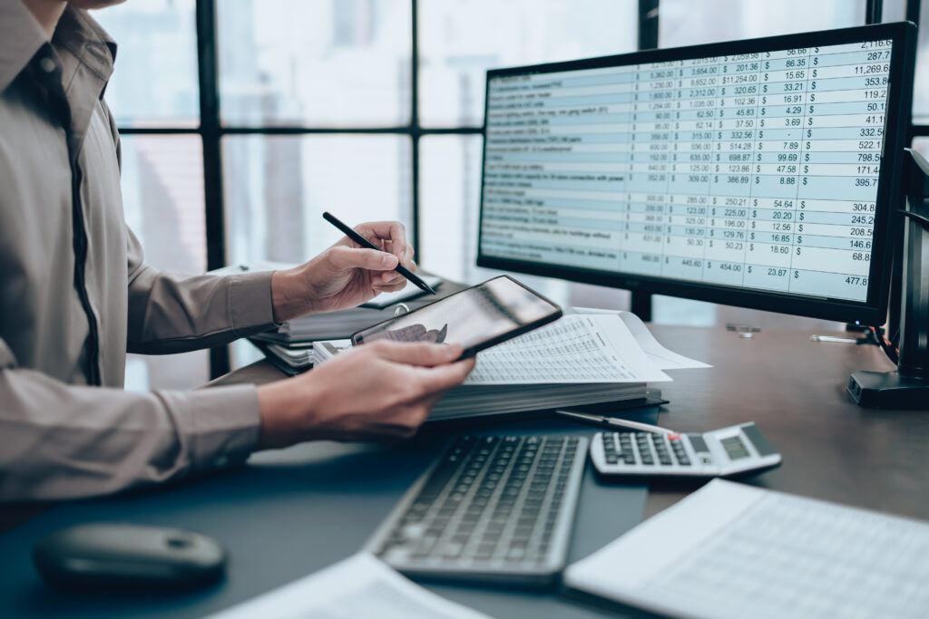 Investors working on desk office and use tablet to  check tracki