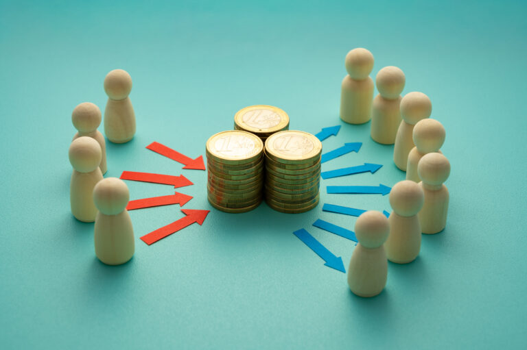 Concept of wealth contribution and redistribution, represented by wooden tokens. Individual economic resources pooled into a common fund and redistributed. Contribution and distribution of resources